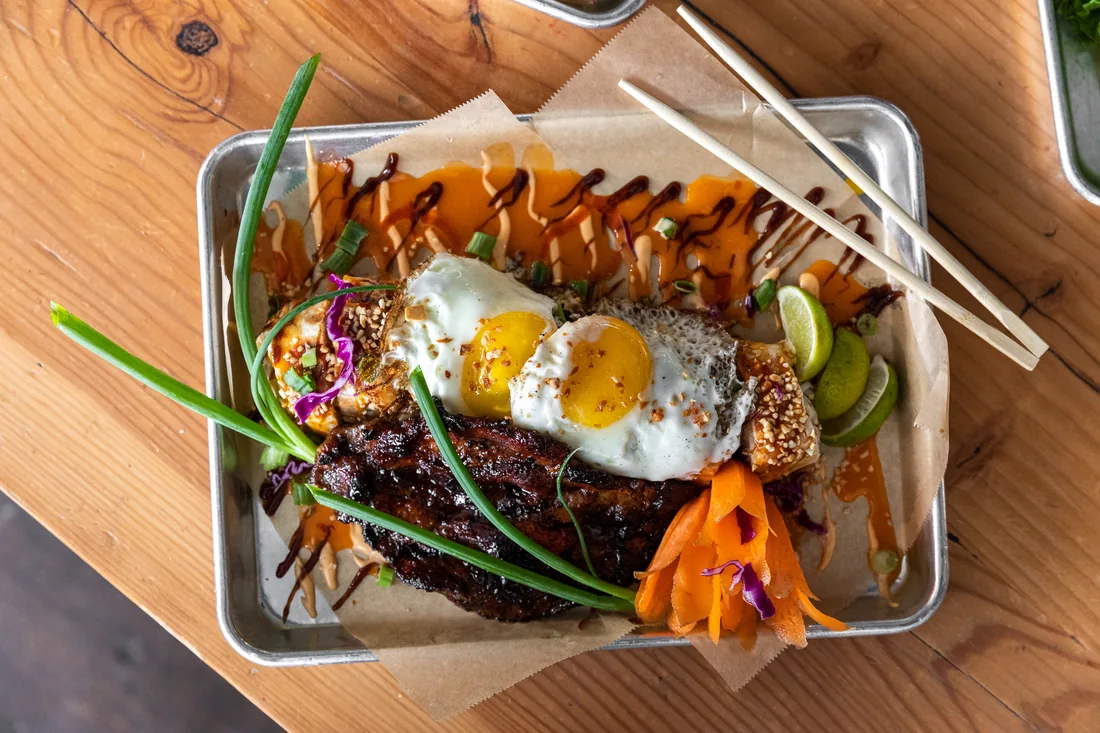 Grilled pork with fried egg and chili drizzle