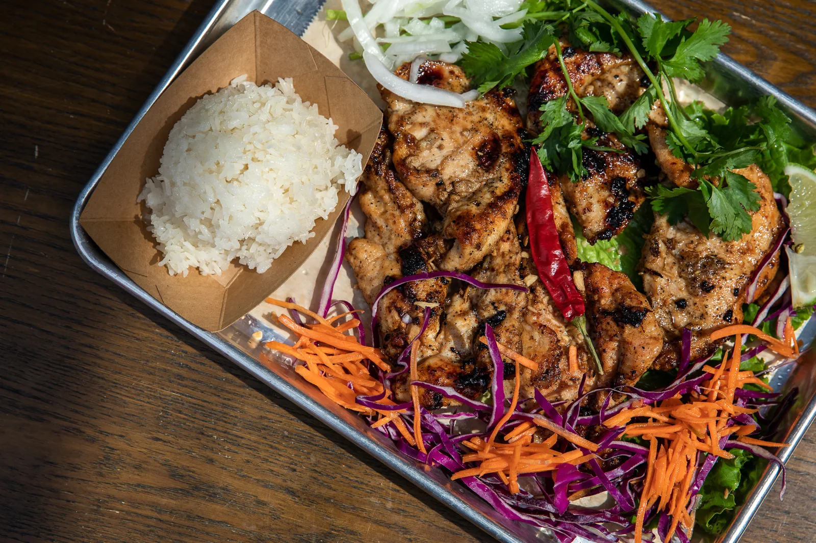 Grilled Thai chicken with sticky rice and slaw at Golden Basil in Anytown