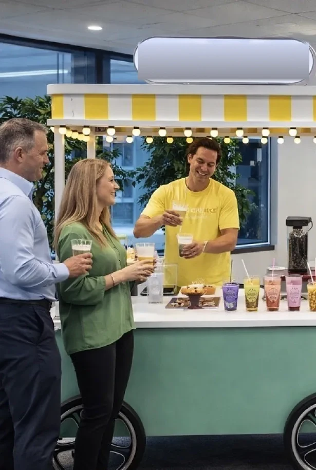 Guests being served Pearl & Mint Tea Co. drinks from the mobile cart at a corporate event