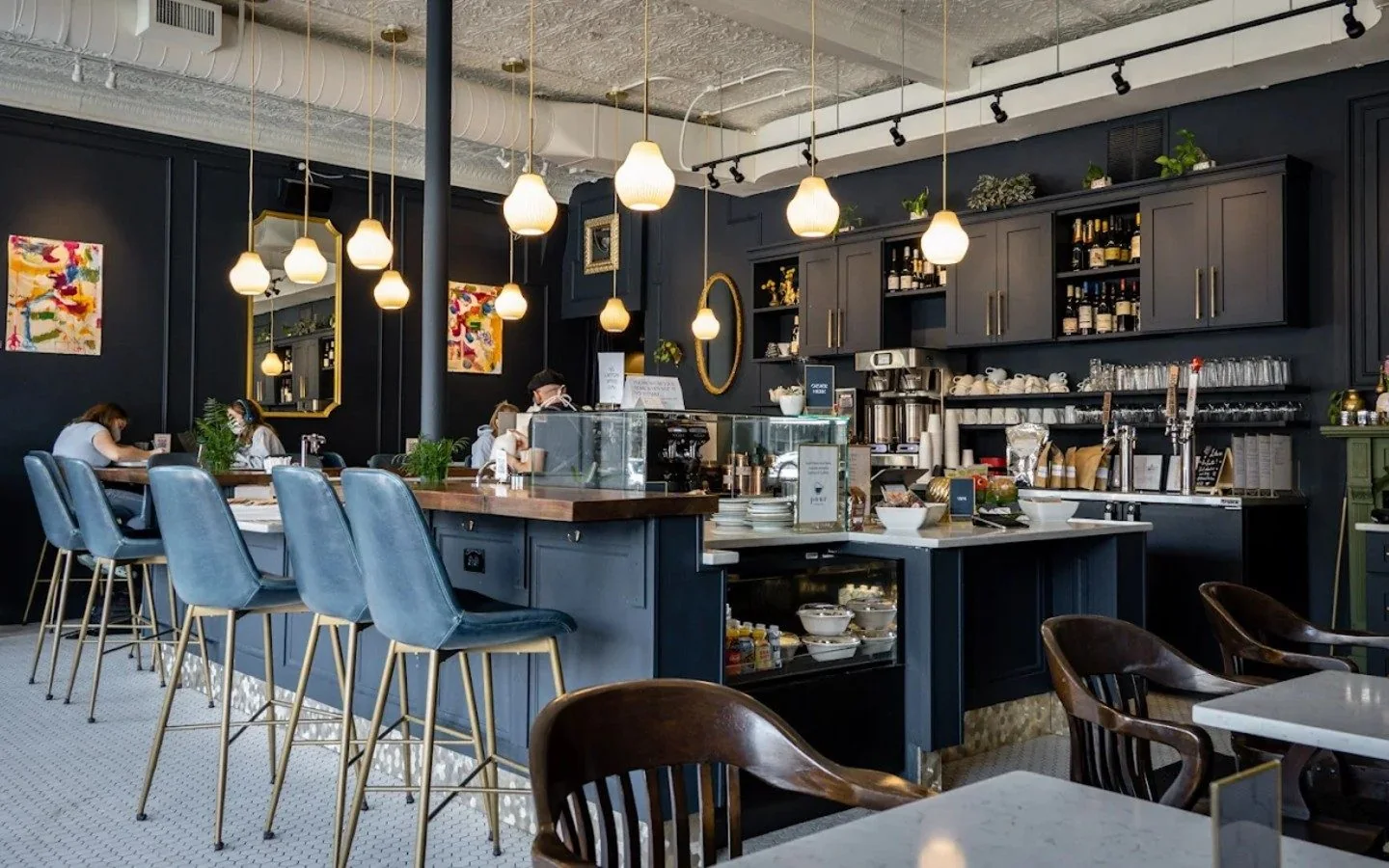 The Template Cafe café interior with blue seating and pendant lighting