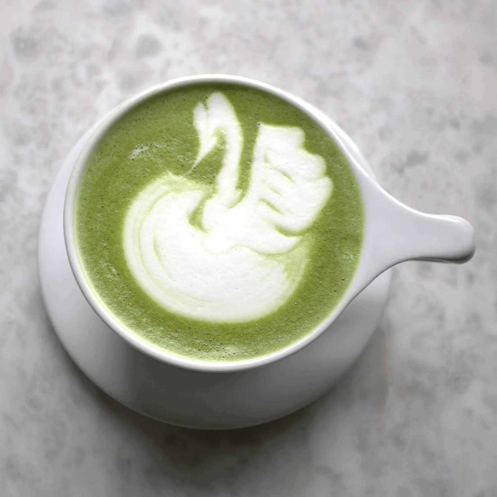 A matcha latte with delicate swan latte art at Bel Horizon Coffee 606