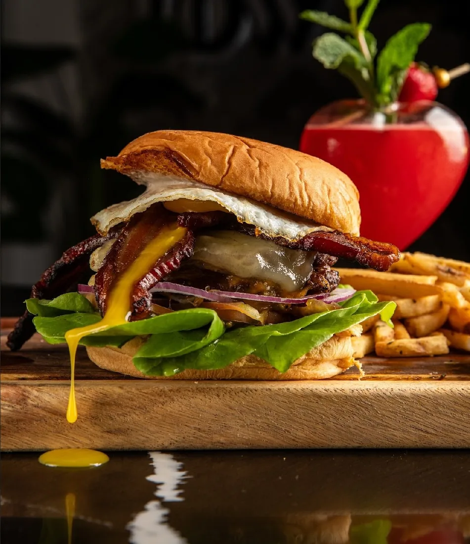 Burger with lettuce, tomato, onion and fries