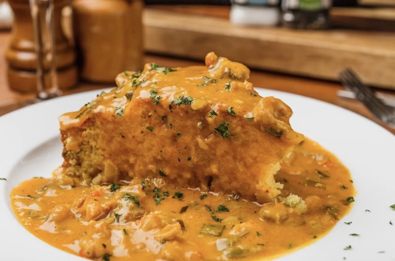 Crawfish etouffee ladled over the plate at Ophelia’s Prime