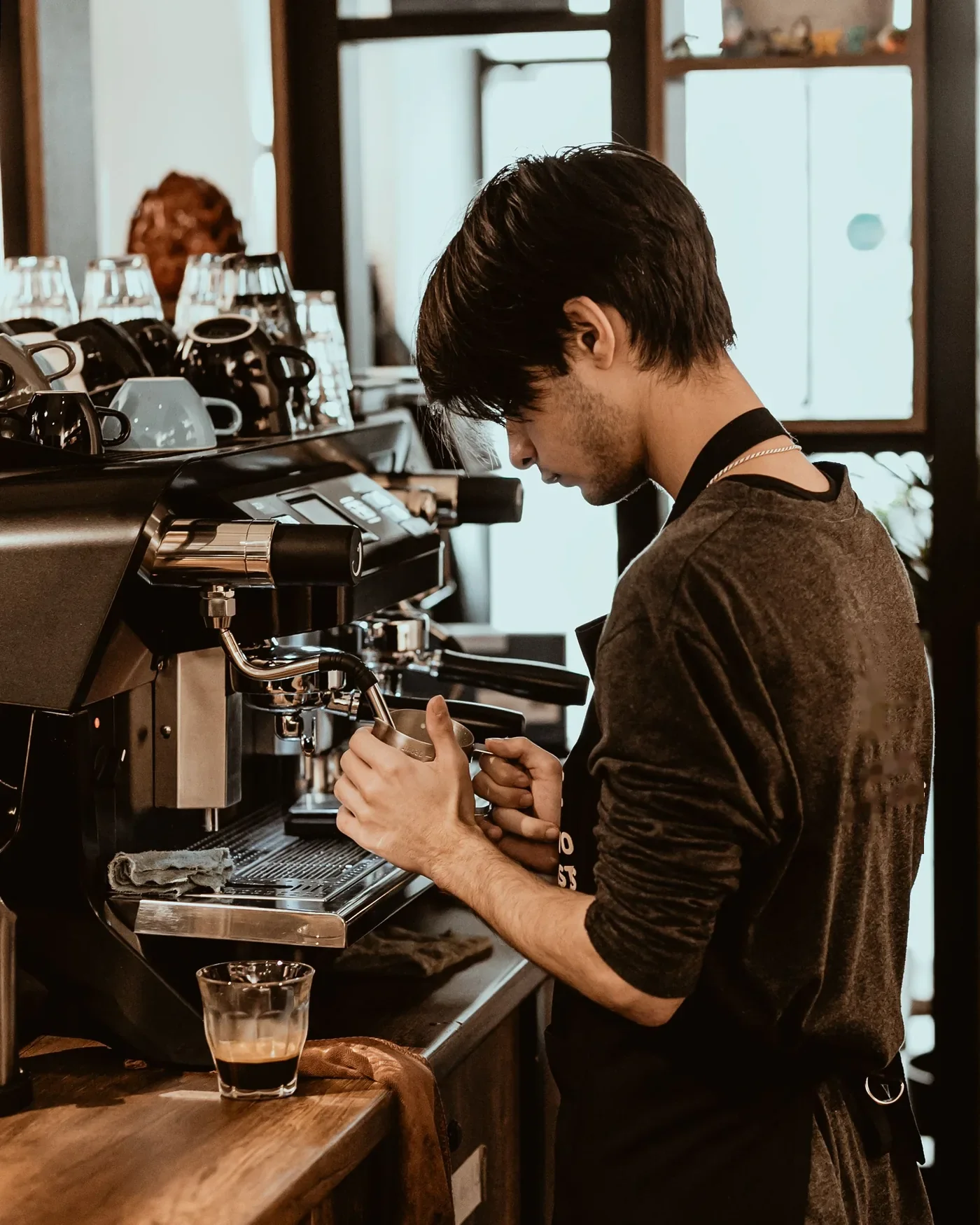 A barista at the group head